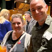 Two alums standing together.